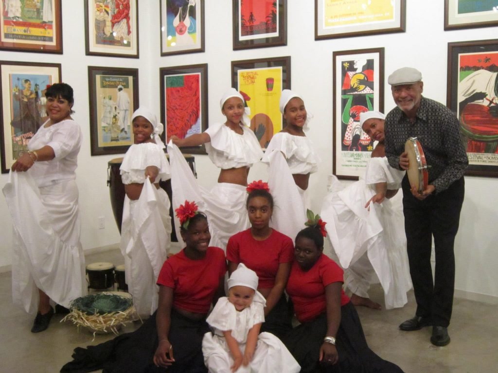 Dance troupe in costume, posing in an art gallery