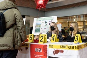 People at an information table about forensic science