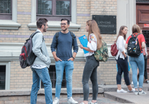 Students talking on a sidewalk