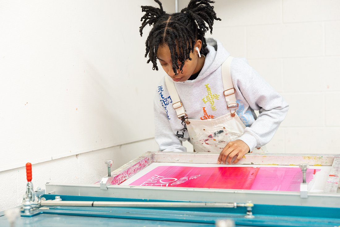 A student works on a screen print