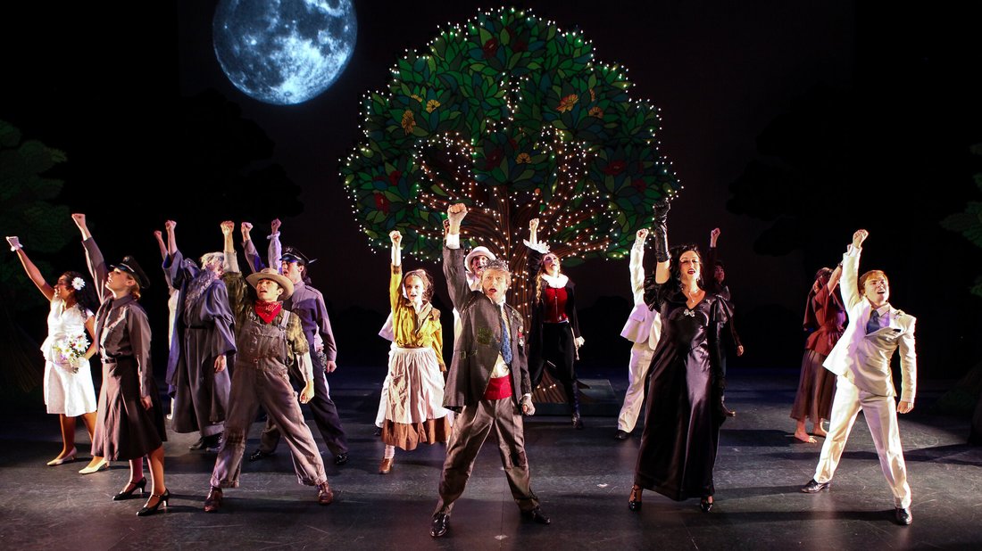 The cast of As You Like It performs a scene in costume on stage