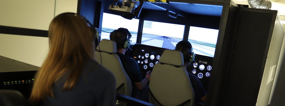 A student in the cockpit of a plane.