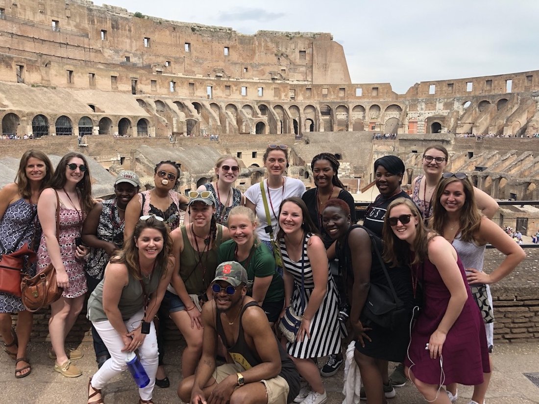 a group of students and faculty at the Roman Colosseum during a study abroad trip to Italy